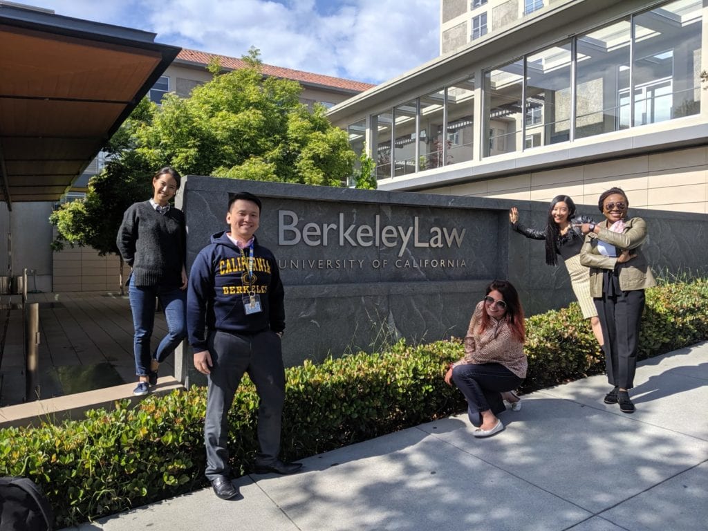 students standing at berkeley law sign